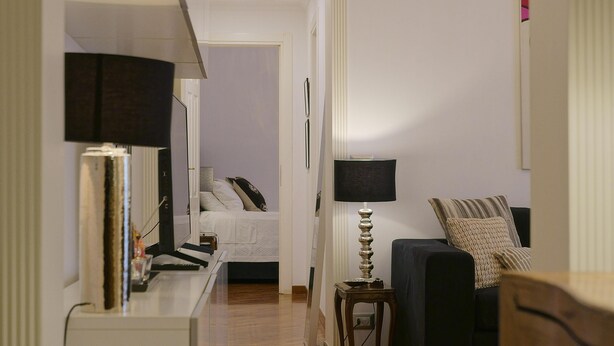 A hotel room with a bed, a bedside table, a lamp, and a sofa. - 2 Bedroom Trastevere (Rome)