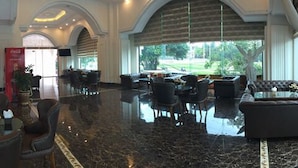 A spacious lobby with leather seating, a bar area, and a view of the outdoors. - Hai Yen Luxury Hotel (Cam Pha)