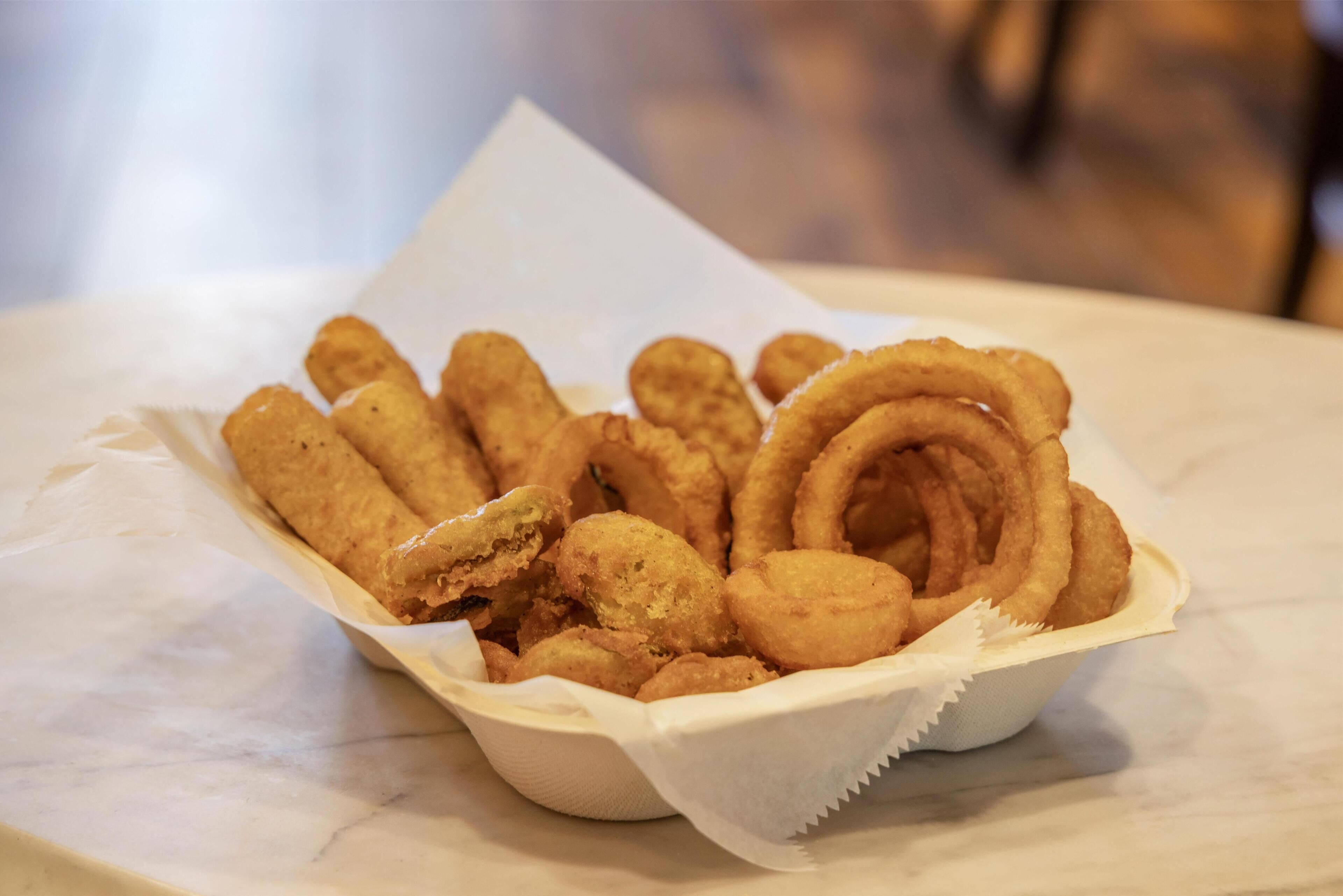 A basket of fried food items on a table.