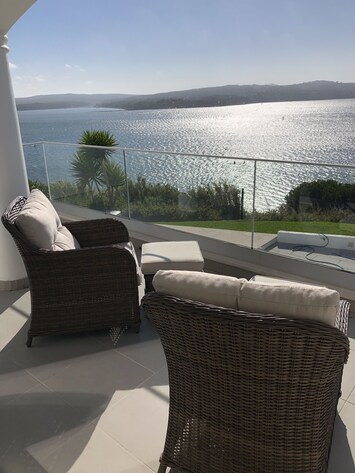 Relaxing seats for sundowners, reading  or  a board game on one Of the balconies