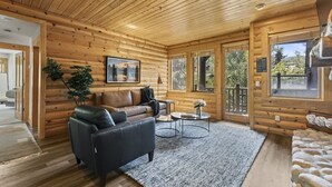 A log cabin interior with a sofa, coffee table, and a painting on the wall. - Abode at Black Bear #353, private hot tub, pool, Deer Valley (Park City)