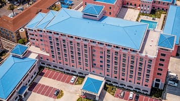 Experience the vibrant atmosphere of the Golden Fraccock Hotel, surrounded by a mix of commercial and residential buildings.