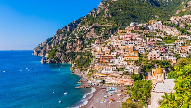A coastal town with buildings built on a hillside overlooking the sea. - Estate4home - GOAT PATH (Positano)