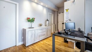A modern office space with a desk, computer, and a small plant.