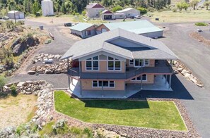 Situated in a semi-rural area, this two-story home features a spacious balcony and a well-maintained lawn.