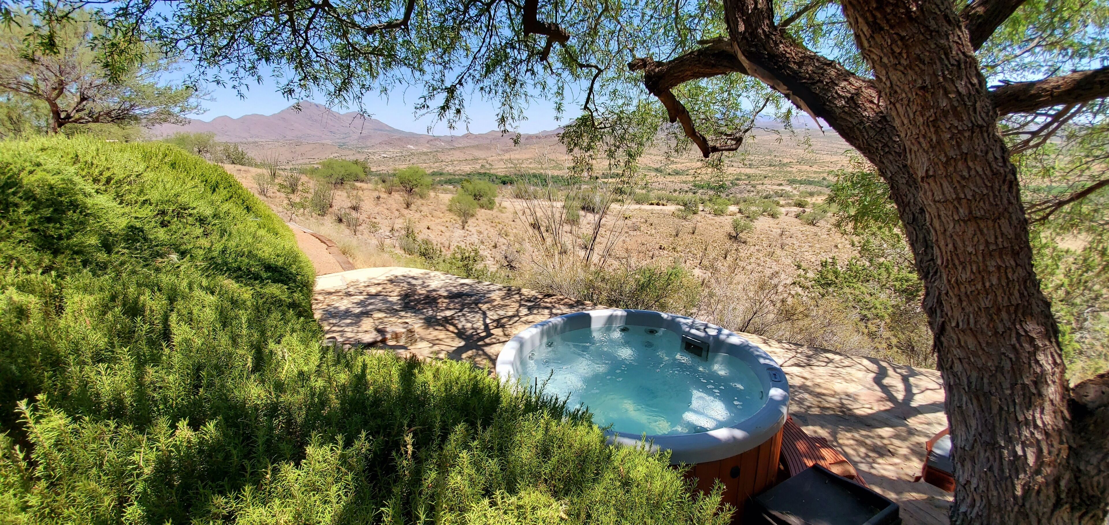 The hot tub just below the main patio with a secluded and beautiful view.