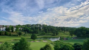 A golf course with sand bunkers, a pond, and surrounding trees. - Luxury Getaway Branson Suite at the Greens at Thousand Hills! Great Rates!  (Branson)