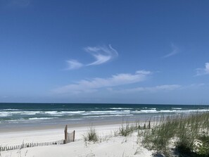 A beach with a wooden fence and sand dunes. - W/D in Unit, Ocean Views Galore, Spectacular Sunrise & Sunset from property (Saint Augustine Beach Florida)