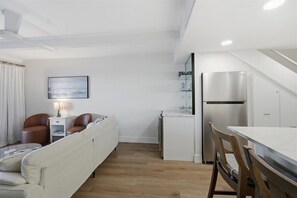 A compact living space with a kitchenette, a dining area, and a seating area with a sofa and chairs. - W/D in Unit, Ocean Views Galore, Spectacular Sunrise & Sunset from property (Saint Augustine Beach Florida)