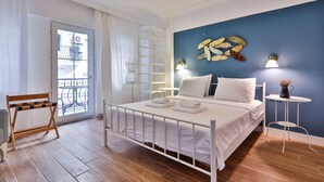 A bedroom with a bed, a small table, a chair, a ladder, and a view of the outside balcony.