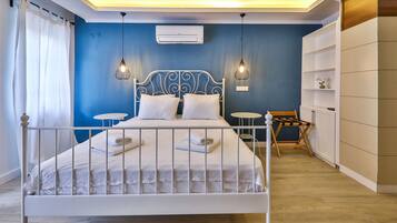 A neatly arranged bedroom with a bed, bedside tables, and a wardrobe.