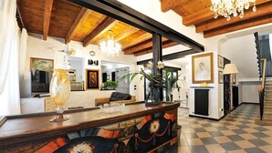 A spacious lobby with a checkered floor, wooden ceiling beams, a reception desk, and a staircase leading upstairs. - Exclusive Villa with Private Pool Sleeps 12 - 6 Rooms (Castelbaldo)