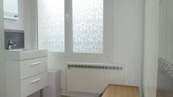 Shower, hair dryer, towels, toilet paper