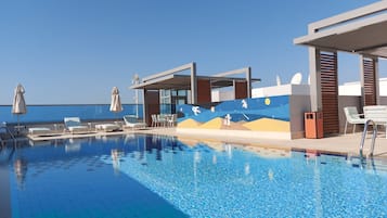 Outdoor pool, open 9:00 AM to 9:00 PM, pool umbrellas, pool loungers