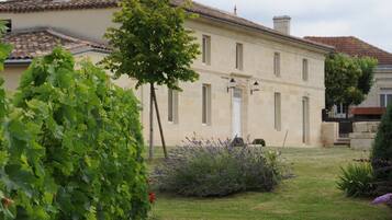 Traditional building with a central entrance and well-maintained garden.