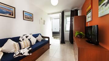 Apartment, 1 Bedroom | Living room | Flat-screen TV