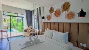 A hotel room with a large bed, a view of the outdoors, and a balcony with a chair. - Raing Phnom Bungalow (Kampot)