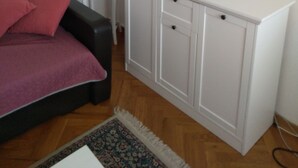 A room with a bed, a white desk, and a cabinet. - Adriatic Sea View Apartment ZOE (Rovinj)