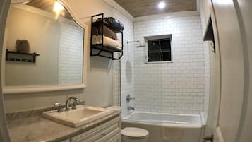 Combined shower/bathtub, hair dryer, towels, toilet paper