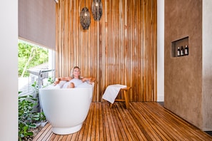 Bathtub, eco-friendly toiletries, hair dryer, towels
