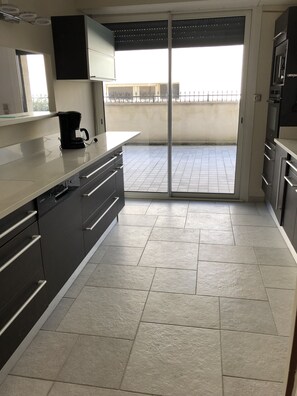 Fridge, dishwasher, coffee/tea maker, cookware/dishes/utensils