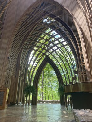 A cathedral interior with high vaulted ceilings and a stone floor.