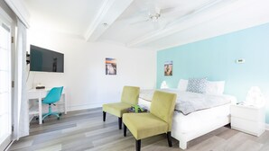 A bedroom with a bed, two chairs, a desk, and a TV. - Rehoboth Beach pet friendly hot tub Canalside Inn (Rehoboth Beach)