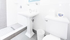 A bathroom with a white sink, toilet, and bidet. - Rehoboth Beach pet friendly hot tub Canalside Inn (Rehoboth Beach)