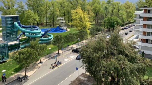 Ein modernes Gebäude mit Parkplatz und Wasserrutsche.