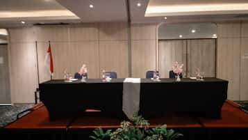 A conference room with a long table, chairs, and a flag.