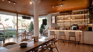 A restaurant with a bar area, outdoor seating, and a view of the city. - FIM by Zigna (Surakarta)