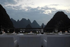 A table set for dining with a mountain view.