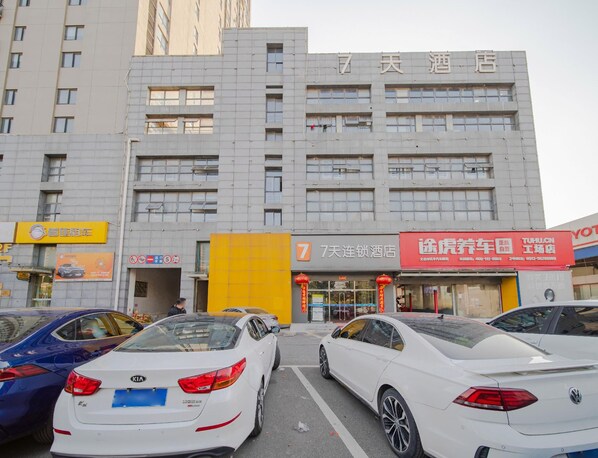 A multi-story building with a prominent number 7 sign, indicating a hotel or similar establishment.