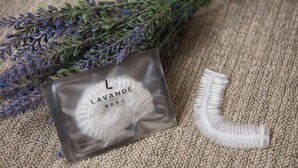 A lavender sachet and a white plastic object on a textured surface. - Lavande Hotel (Zhuanghe Xiangyang Road) (Zhuanghe)