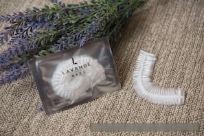 A lavender sachet and a white plastic object on a textured surface. - Lavande Hotel (Zhuanghe Xiangyang Road) (Zhuanghe)