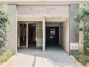 Welcome to Fendrel Yabu, where sleek glass and metal elements frame the entrance to a stylish building.