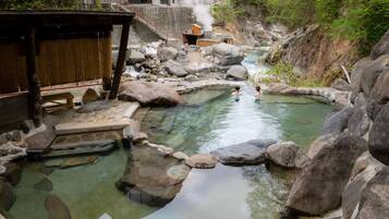 Relax in a serene natural setting surrounded by large rocks and lush greenery.
