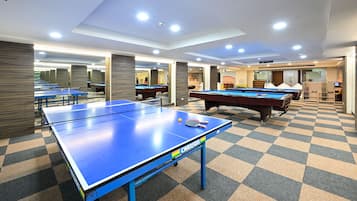 Enjoy a game of ping pong or pool in our indoor recreational area, featuring a ping pong table and billiards equipment.