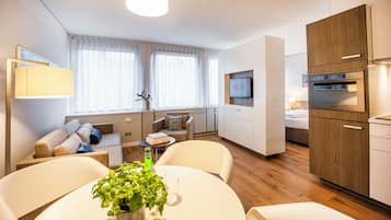 Apartment L - King bed | Living area | 20-inch flat-screen TV with cable channels, TV