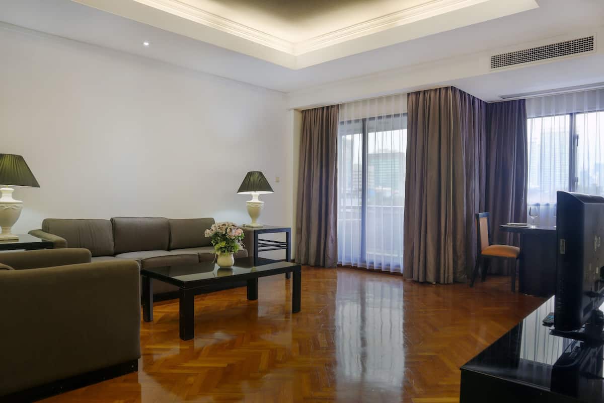 A modern living room with a sofa, coffee table, and TV.