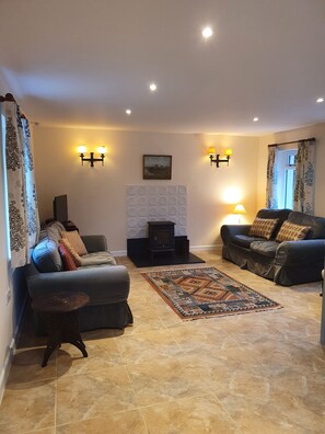 Relax in a cozy living room with a central seating area, fireplace, and decorative rug.
