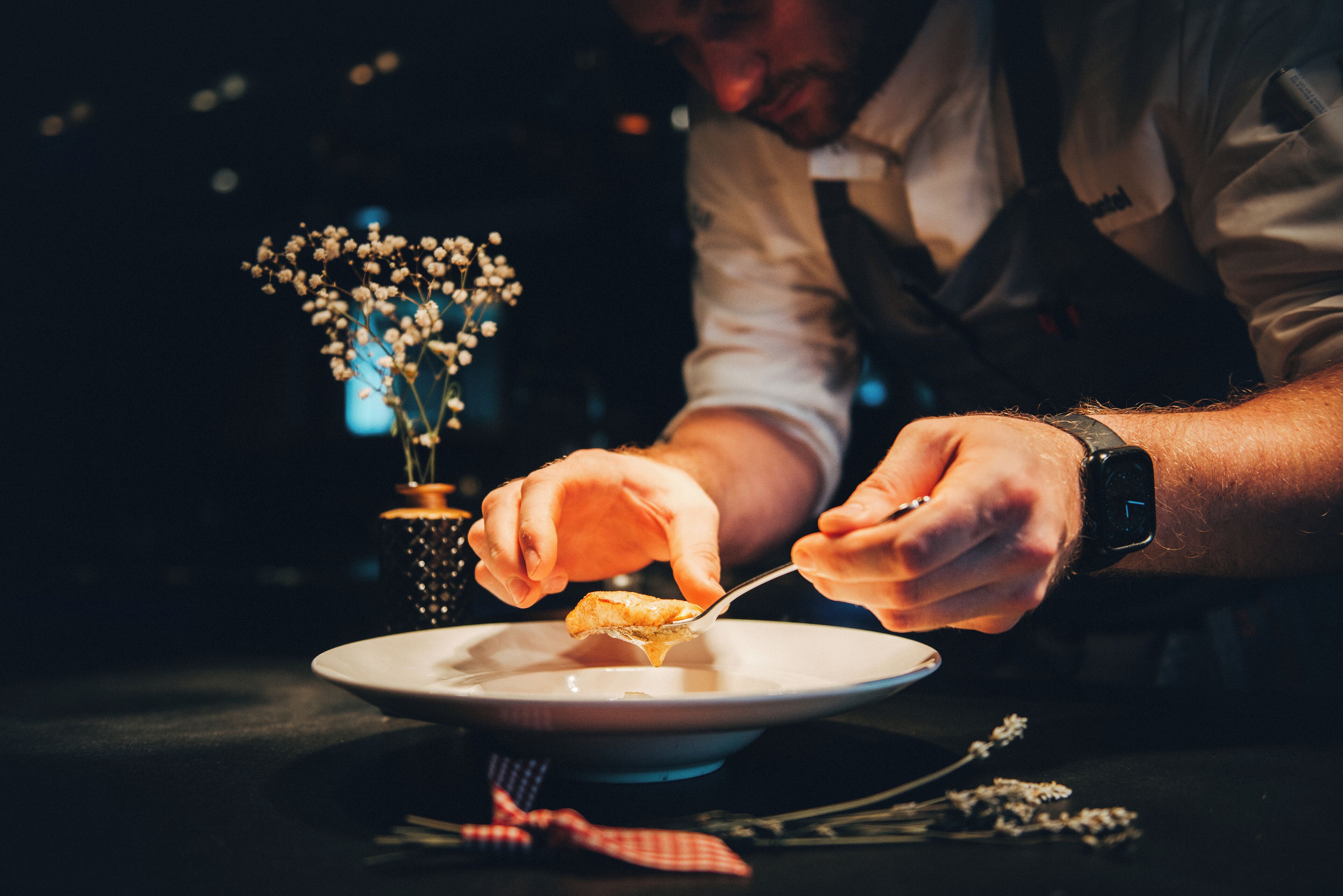 A person serving food from a plate.