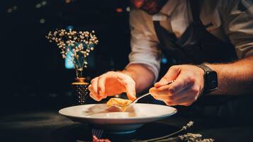 A person serving food from a plate.