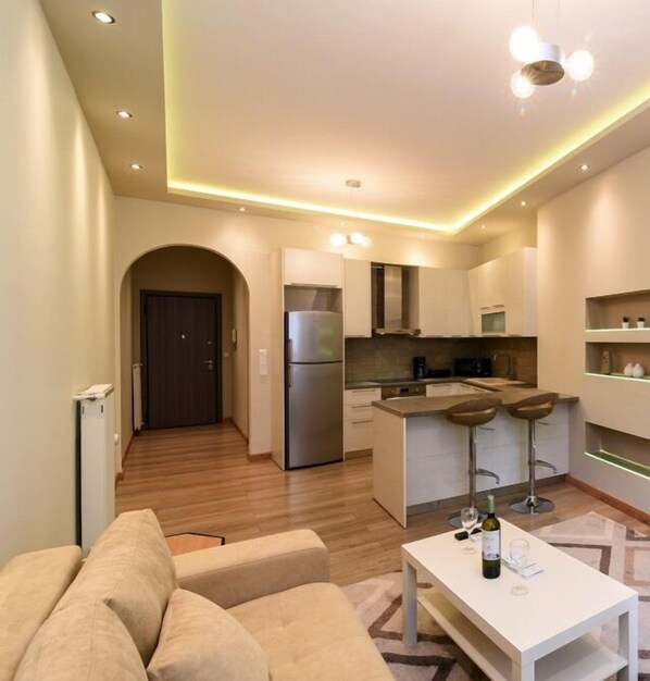 Apartment, 1 Bedroom | Living area | 20-inch flat-screen TV with cable channels, Smart TV