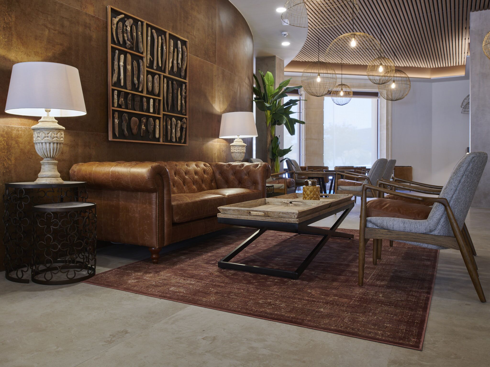 A modern living room with a leather sofa, a coffee table, and a bookshelf.