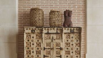 A wooden cabinet with intricate carvings and two decorative items on top.