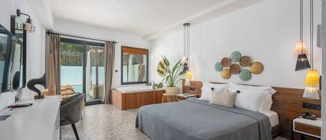 A modern bedroom with a large bed, bedside tables, a desk, and a window with curtains.