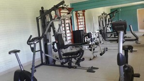 Work out in comfort with a fully equipped gym featuring weight machines, a bench, and a stationary bike.