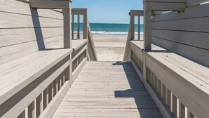 A wooden boardwalk leading to a beach with a clear view of the ocean. - Sea-breezin' - Beachfront Condo                   (Surfside Beach)