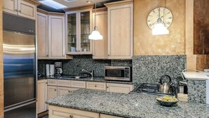 A kitchen with granite countertops, stainless steel appliances, and light wooden cabinets. - Old-World, Classic Building Downtown (Chicago)